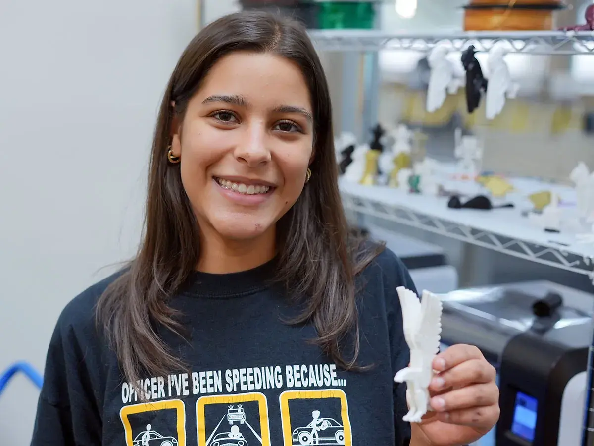 A student displays object created in the Makerspace at Scott Northern Wake Campus Library