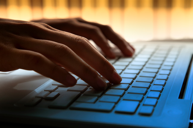 Person typing on computer keyboard